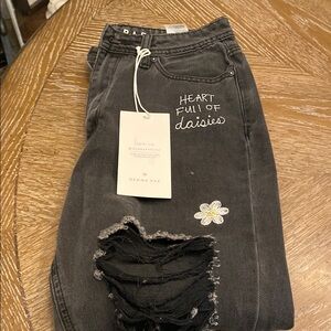 Black Skinny Jeans with Distressed Detailing and Floral Embellishment